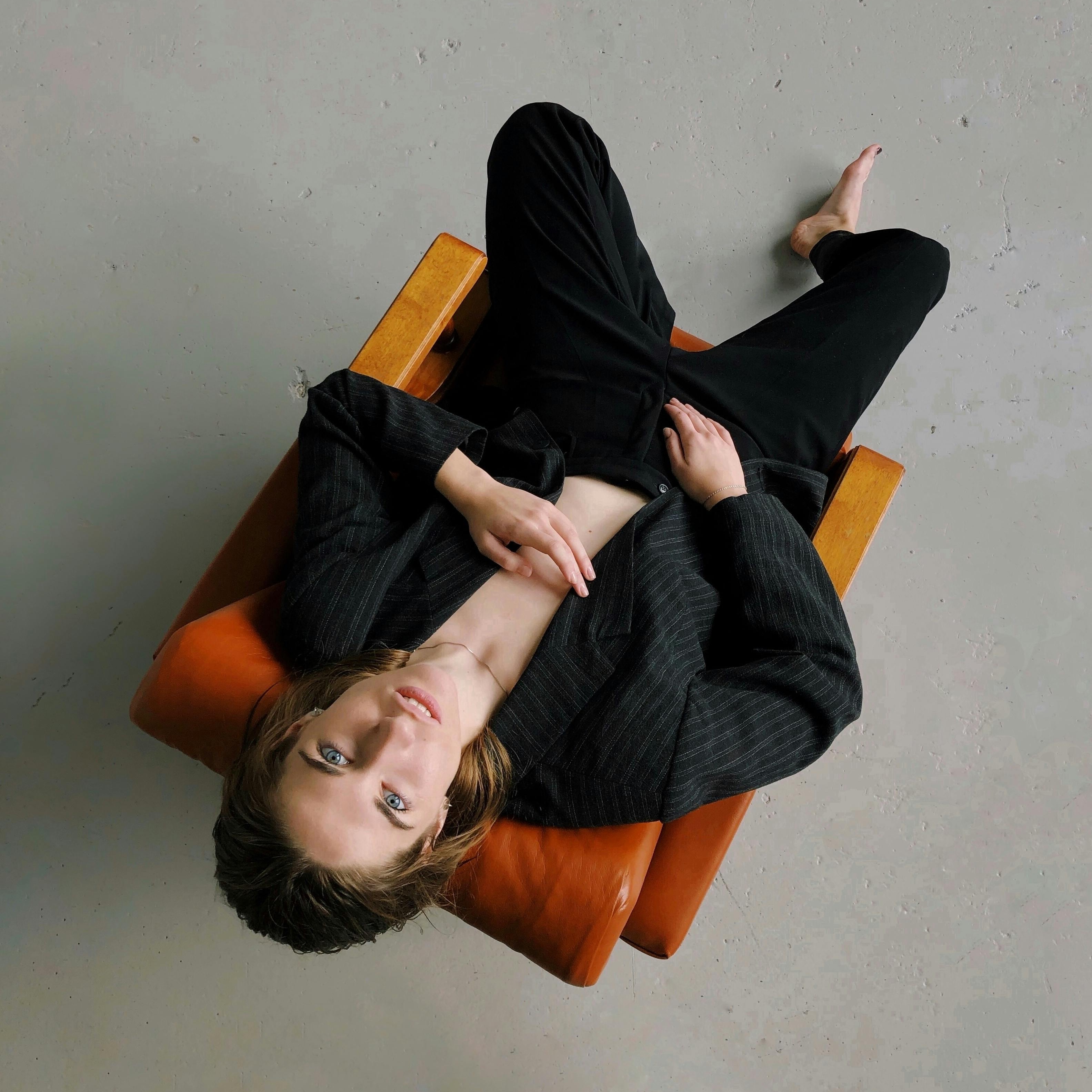 Person lounging on vintage armchair